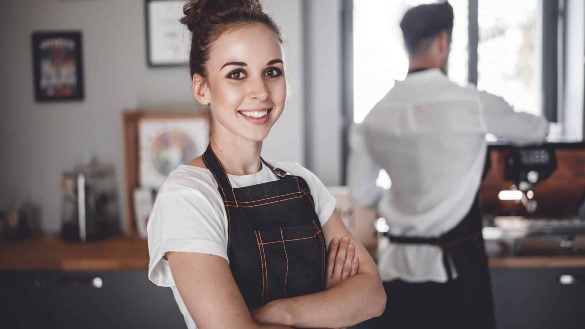 Smiling woman barista in apron, Coffee business owner